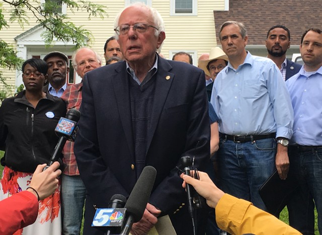 Sen. Bernie Sanders addresses reporters Sunday outside his Burlington home. - PAUL HEINTZ