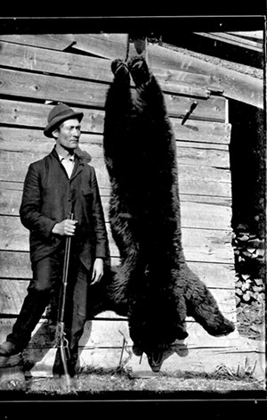 Hunter with bear - COURTESY