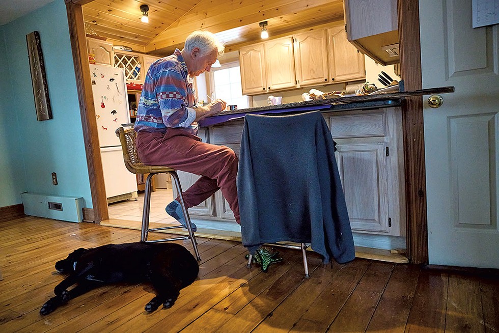 Tim Brookes working while his dog, Flash, is of no help at all - BEAR CIERI