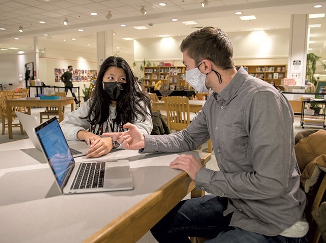 Samjana Rai discussing her college essay with Adam Hurwitz of the University of Vermont's Upward Bound program in the Burlington High School library - DARIA BISHOP