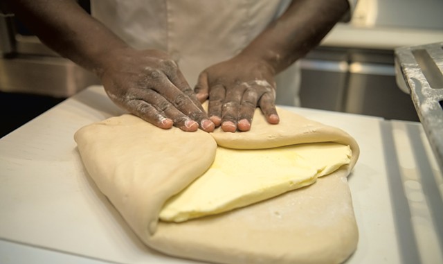 Chris Johnson folding butter into dough during the lamination process - DARIA BISHOP