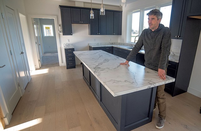Jason Webster in the kitchen of an energy-efficient TruHome model at Huntington Homes - JEB WALLACE-BRODEUR
