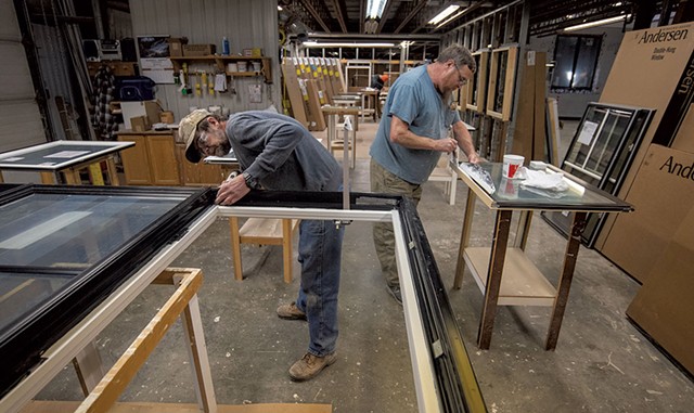 Mike Keough (left) and John Smith assembling and painting windows at Huntington Homes - JEB WALLACE-BRODEUR