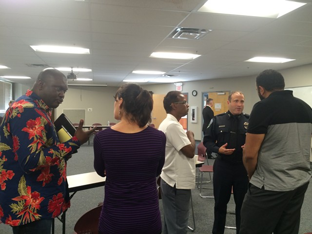 Cléophace Mukeba, left, talks about diversifying the BPD ranks, while Chief Brandon del Pozo chats with Farhad Khan and Imam Islam of the Islamic Society of Vermont. - ALICIA FREESE