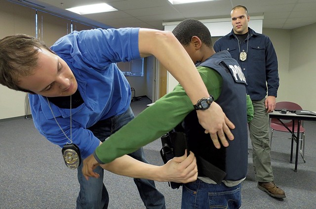 "What's this vest made of?" this boy asked. "Kryptonite," said Officer Daniel Delgado (right), straight-faced.