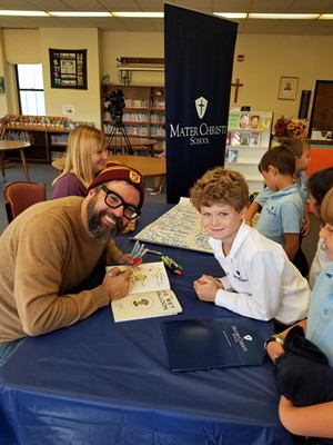 Liniers signs books at Mater Christi School - COURTESY OF MATER CHRISTI SCHOOL