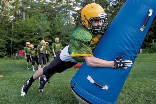 Eighth grader Jake Labell practices his tackling technique at a Colchester Catamounts preseason practice - JAMES BUCK
