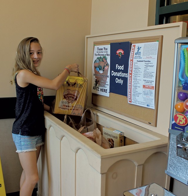 Hannah Smiley making a donation to the Milton Food Shelf (Activity 60)
