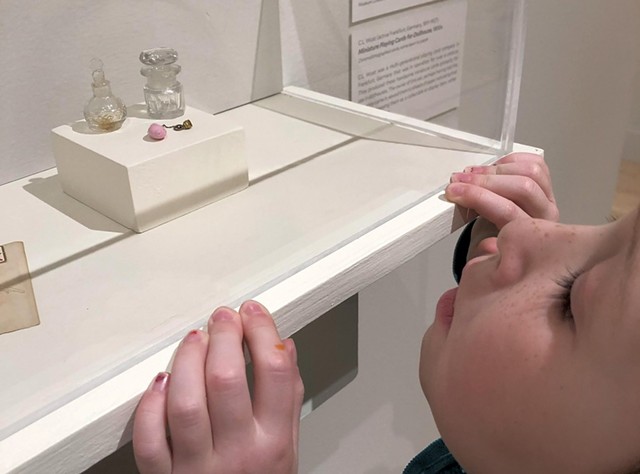 Ruby examines miniature glassware from the museum's global collection - HEATHER POLIFKA-RIVAS