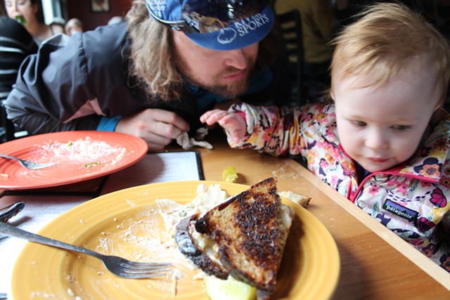 Elise helps eat a tempeh Reuben sandwich at Lost Nation Brewing - COURTESY SARAH GALBRAITH