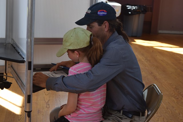 David Zuckerman, a Democratic candidate for lieutenant governor, votes with daughter Addie at the Hinesburg Town Hall on Tuesday afternoon. - TERRI HALLENBECK