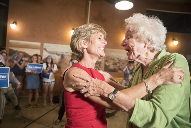 Democratic gubernatorial nominee Sue Minter embraces former governor Madeleine Kunin Tuesday night in Burlington. - JAMES BUCK