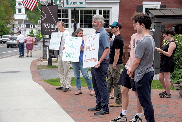 A group of protesters holding a rally in downtown Stowe - JEB WALLACE-BRODEUR