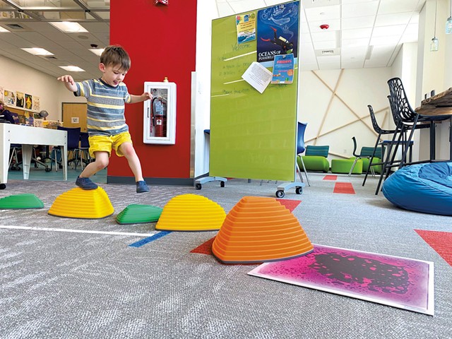 Playing on a mini obstacle course at the South Burlington Public Library - JULIE GARWOOD