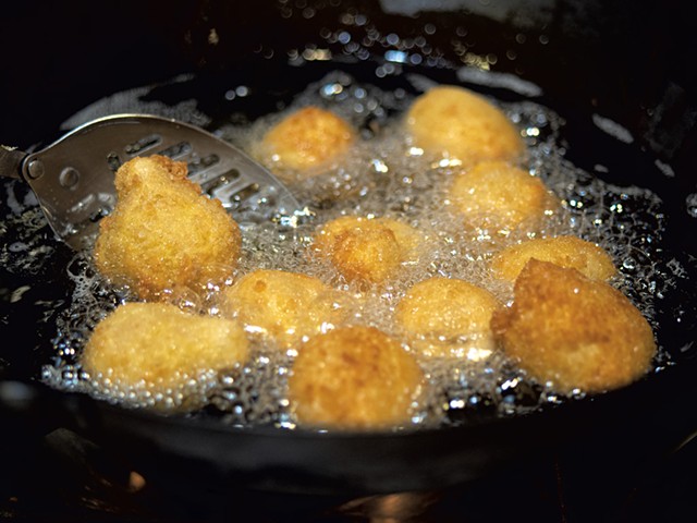 Coxinhas cooking in oil - ANDY BRUMBAUGH