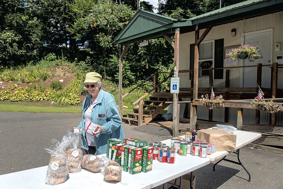Kay Curtis picking up donated food in front of the Tri-Park Cooperative Housing office - DARIA BISHOP