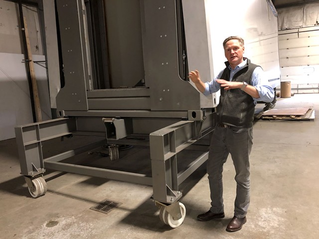 Tenfold Engineering owner David Jaacks with a prototype of the folding modular structures he hopes to start building this year. - ANNE WALLACE ALLEN ©️ SEVEN DAYS