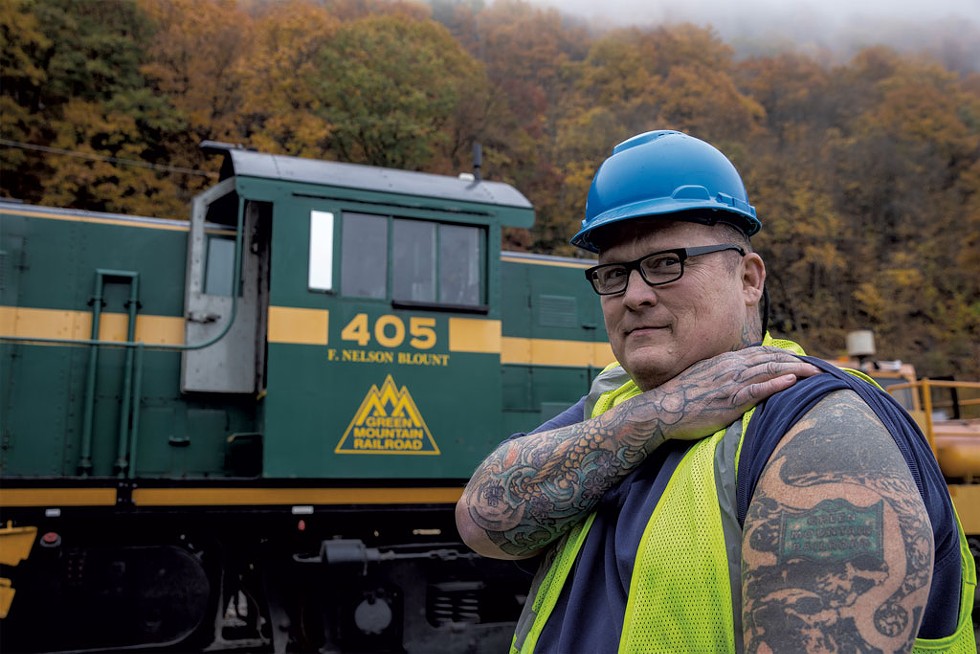 Aaron Bridge, superintendent of railcar repair at Vermont Rail repair yard, has a tattoo that says "Green Mountain Railroad." - JAMES BUCK