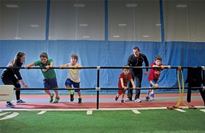 Performance coach Lauren Green and program director Mike Porter lead a Jump Start class, for ages 7 to 11, through the Wall Drive, an acceleration drill. - MATTHEW THORSEN