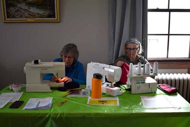 Marie Jewett (left) and Jessica Breault mending items at the Clothing Repair Fair - SOPHIA AFSAR-KESHMIRI ©️ SEVEN DAYS