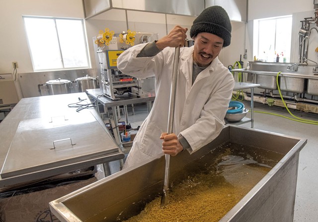 Operations manager Daiki Hirano stirring soybeans at Rhapsody Natural Foods - JEB WALLACE-BRODEUR