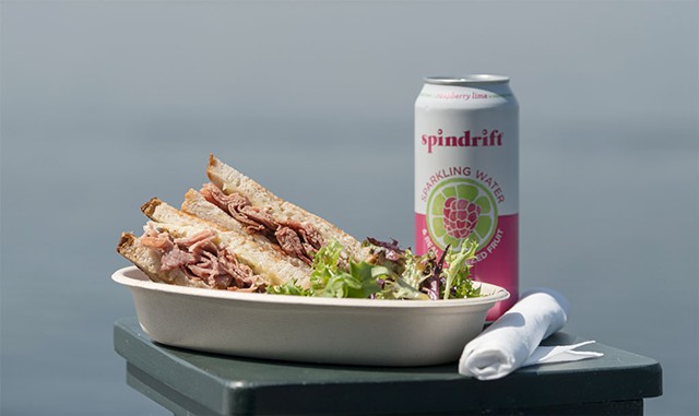 Montr&eacute;al smoked meat sandwich with greens and a seltzer - DARIA BISHOP
