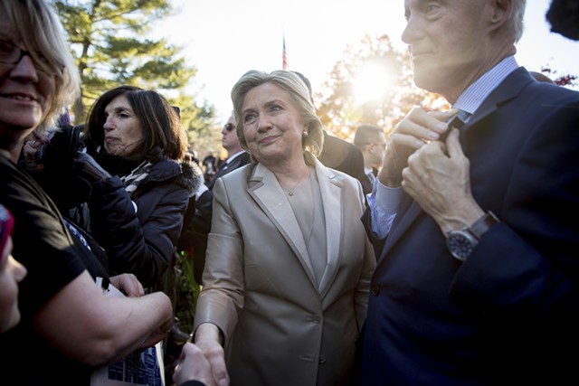 Hillary Clinton, accompanied by her husband, former President Bill Clinton, right, greeting supporters in Chappaqua, N.Y., after voting on Tuesday - AP PHOTO/ANDREW HARNIK