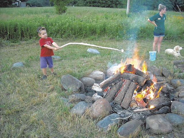 Making s'mores over a campfire - COURTESY