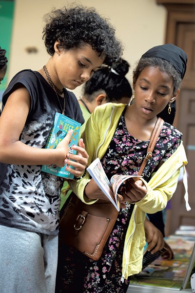 Children checking out free book options at a CLiF event at Fletcher Free Library - LUKE AWTRY