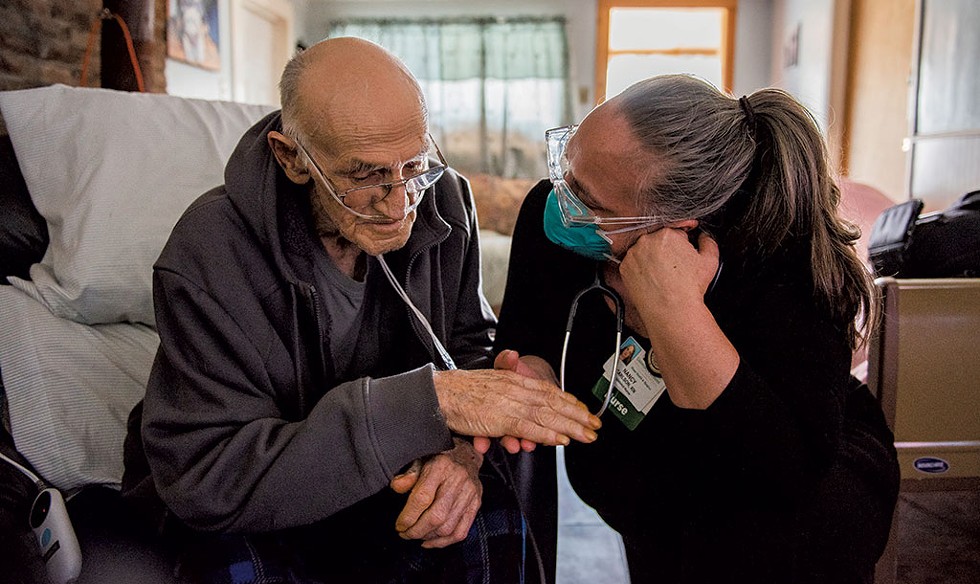 Nancy Carlson, RN, of the UVM Health Network &ndash; Home Health &amp; Hospice, soothes one of her patients during a home visit - RYAN MERCER, UNIVERSITY OF VERMONT HEALTH NETWORK