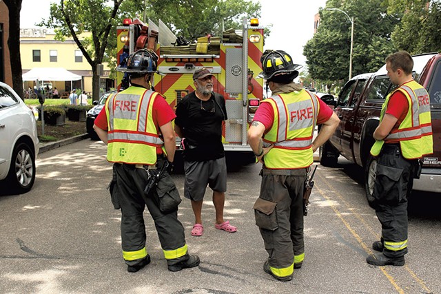 Wayne Savage talking with Burlington firefighters at a crash scene - COURTNEY LAMDIN ©️ SEVEN DAYS