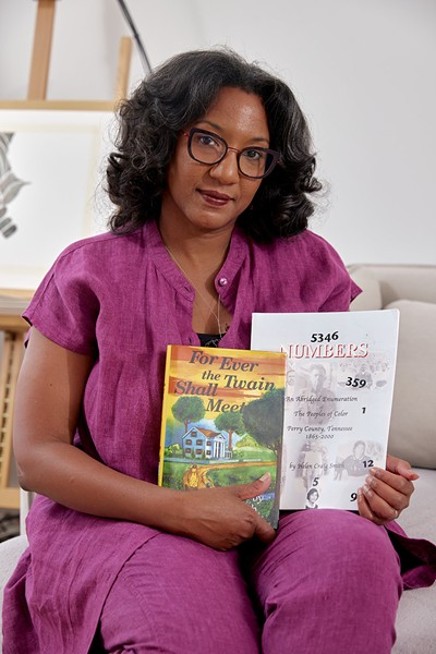 Lacretia Johnson Flash with the historical novel and history book written by her mother's cousin - COURTESY OF SASHA PEDRO