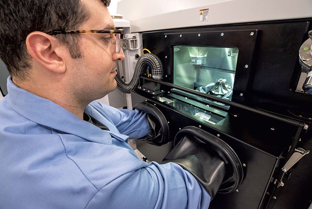 Engineer Nikolas Eliopoulos working with metal additive technology at the Advanced Manufacturing Center - JEB WALLACE-BRODEUR