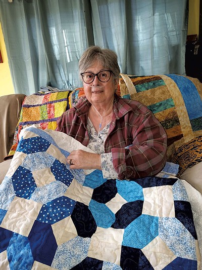 Jane Erickson with quilts - COURTESY