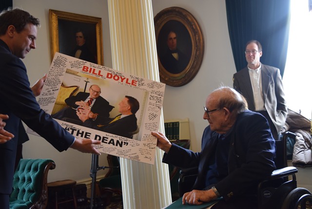Senate President Pro Tempore Tim Ashe (D/P-Chittenden) presents former senator Bill Doyle with a signed photo Tuesday. - TERRI HALLENBECK