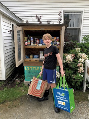 Oliver Raymond with donations for the Hinesburg Little Free Pantry - COURTESY