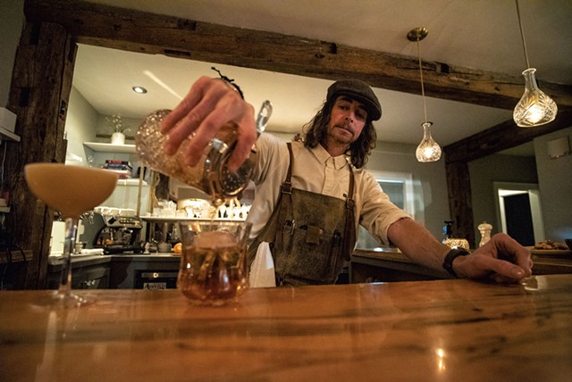 Bartender Ian Budd pouring an old-fashioned cocktail - JEB WALLACE-BRODEUR