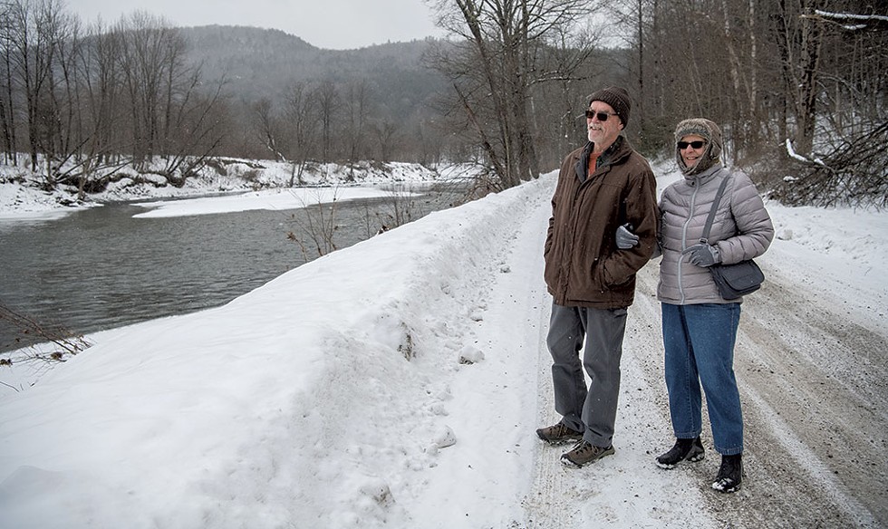 Doug and Jeanne Landry by the Lamoille River in Johnson - DARIA  BISHOP