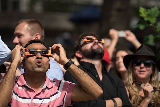 Spectators looking up at the partial solar eclipse in New York in 2017 - MIHAI COMAN | DREAMSTIME