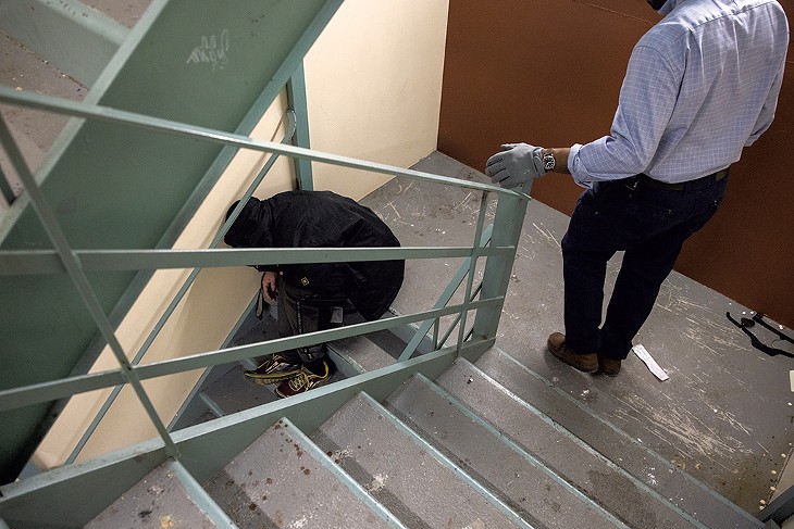 Burlington Housing Authority employee Jeffrey Edwin (right) conducting a morning sweep to evict homeless people from the stairwells - JAMES BUCK