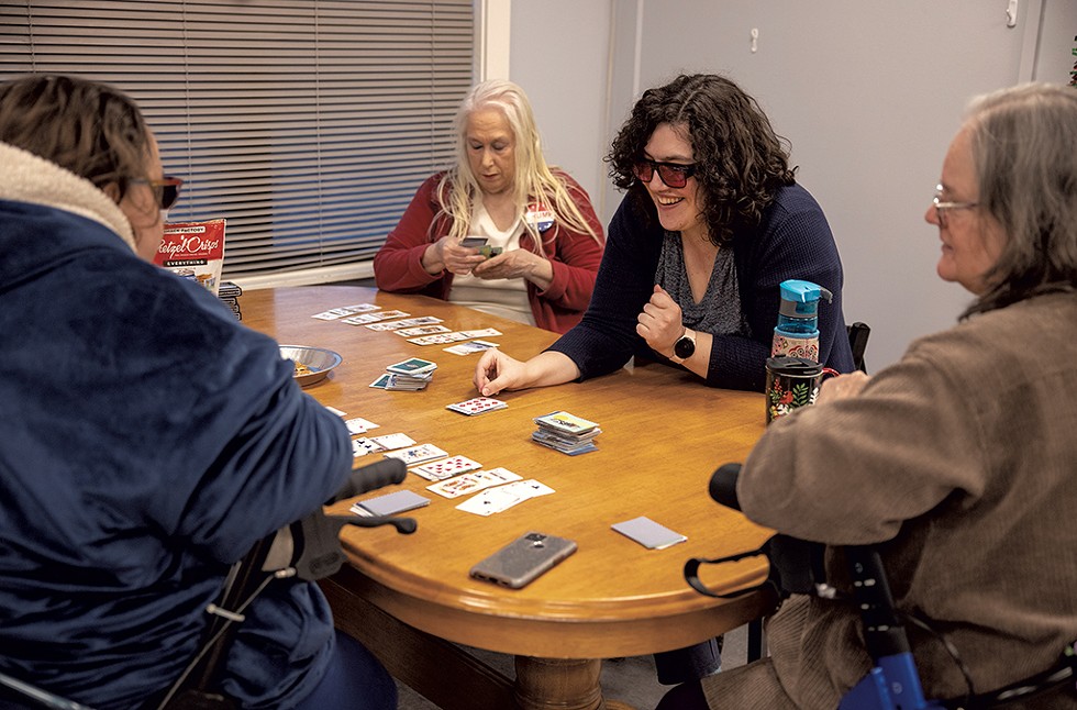 From left: Residents Sarah Procopio, Victoria Carter, Abbie Wolff and Debbie Phelps playing cards on a Sunday afternoon - JAMES BUCK