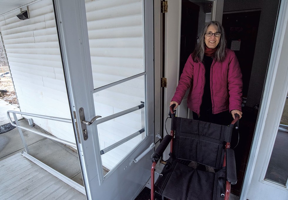 Adrianne Scucces pushing a wheelchair at the home in Barre Town where she cares for her 97-year-old mother - JEB WALLACE-BRODEUR