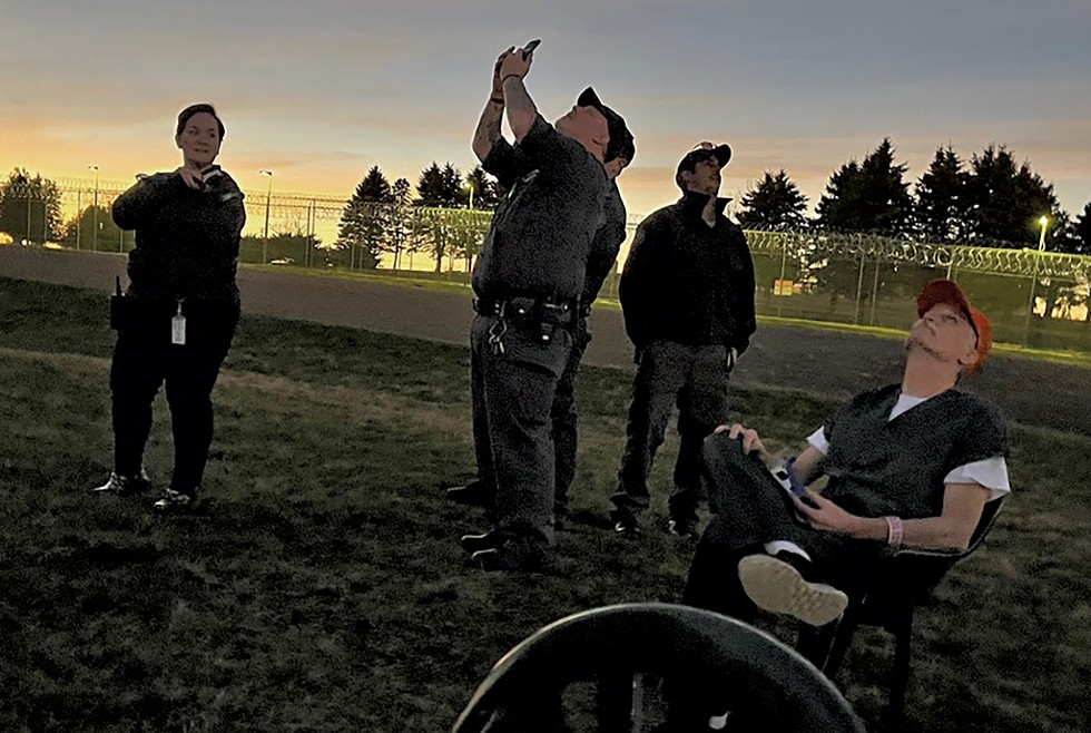 Inmates and guards watching the eclipse - STEVE GOLDSTEIN