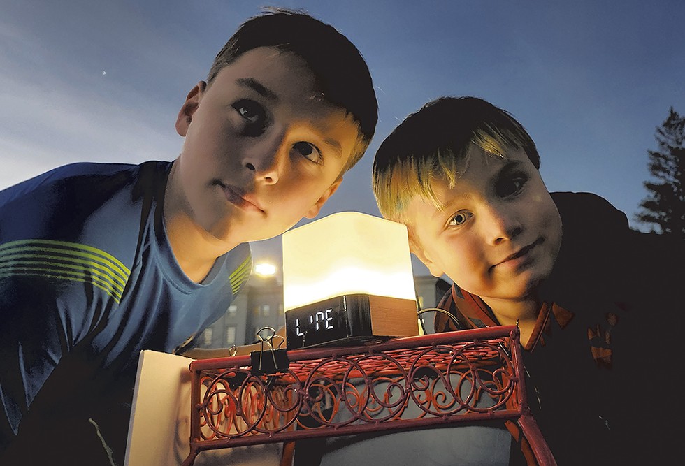 Cedar Eldridge (left) and his brother, Wyatt, listening to a LightSound device - KEVIN MCCALLUM ©️ SEVEN DAYS