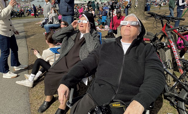 Sr. Lois (left) and Sr. Christopher, Carmelite Sisters for the Aged and Infirm, drove from New York's Hudson Valley to watch the eclipse at Perkins Pier in Burlington. - CATHY RESMER ©️ SEVEN DAYS