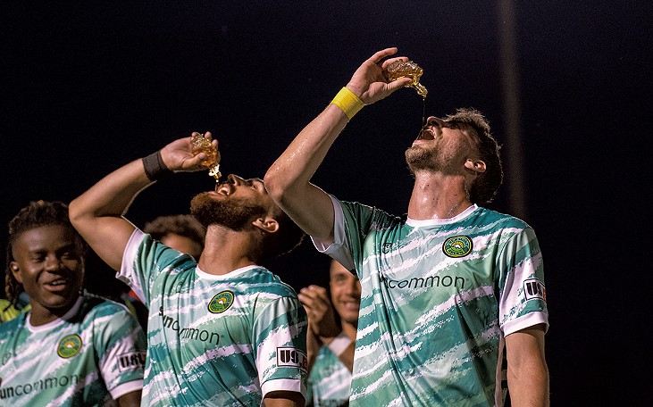 Vermont Green players celebrating with a shot of maple syrup - COURTESY OF JA DOLEN