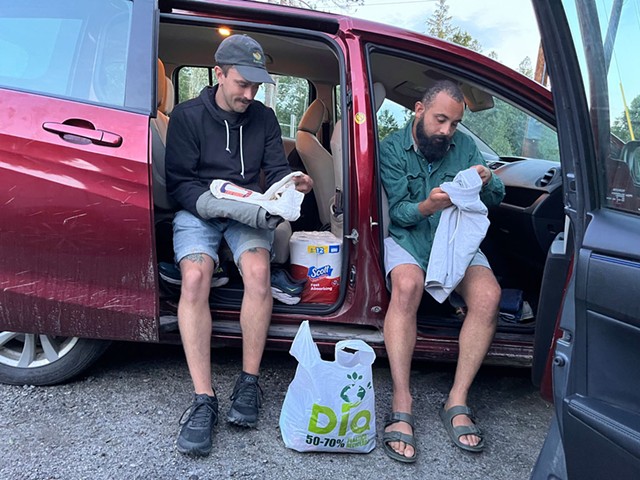 Eli Barlow and Jake McBride looking over donated clothing - ANNE WALLACE ALLEN ©️ SEVEN DAYS