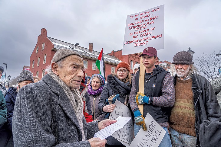 Jules Rabin at his 100th birthday protest in Montpelier with supporters including his grandchildren Eva and Lucien Theriault (center) and friend Peter Schumann (right)