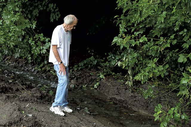 Rich Beck by the creek that overflowed - STEVE LEGGE