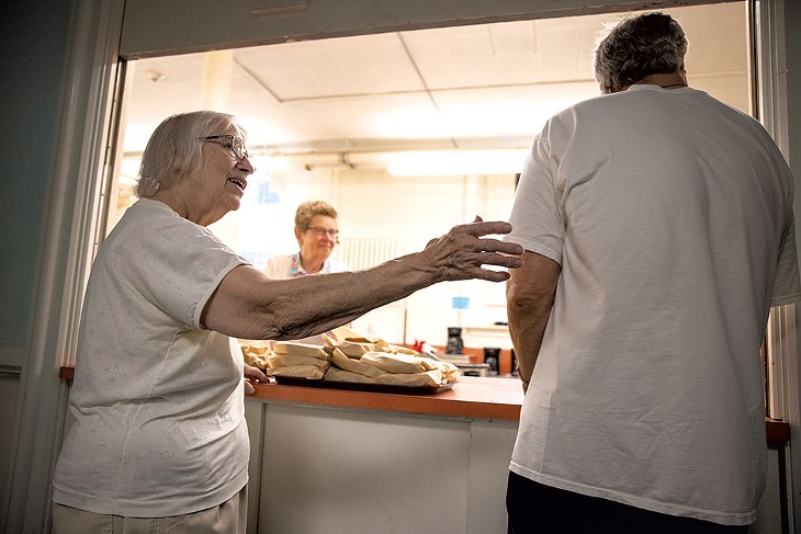 Volunteers serving a free meal at First United Methodist Church - JAMES BUCK